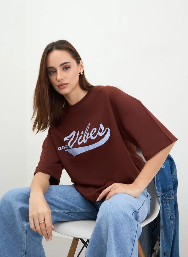 Styli Women Oversized Brown Slogan Print T-Shirt