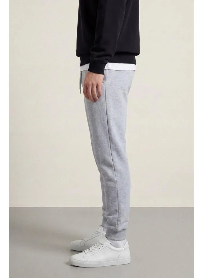 mmetalic Men’s Grey Regular Fit Sweatpants with Back Pocket Label and Elastic Leg Openings.