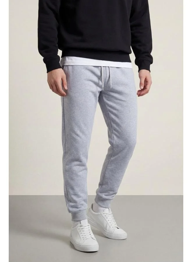 mmetalic Men’s Grey Regular Fit Sweatpants with Back Pocket Label and Elastic Leg Openings.