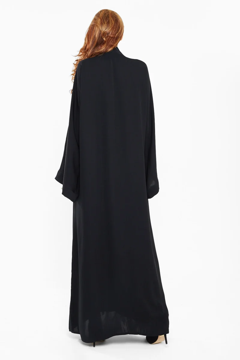 النخبة A trendy one in white with black leafy embroidery on sleeves and one side of the abaya-AJ430A