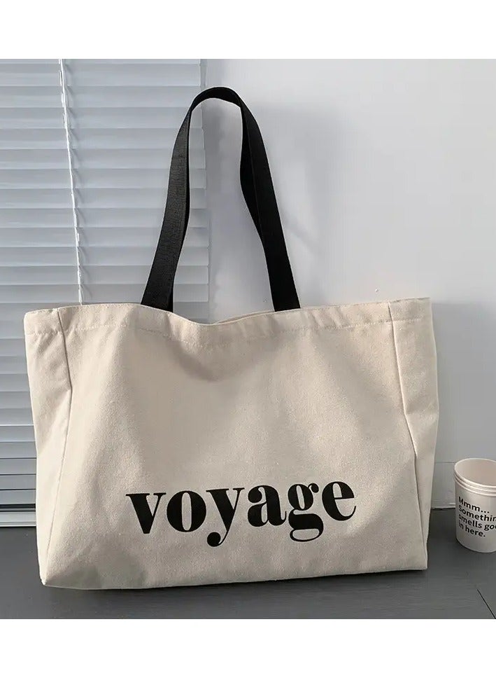 A large-capacity women's canvas tote bag suitable for various occasions such as school, travel, and shopping, with a shoulder strap, in beige color.  - Image 1
