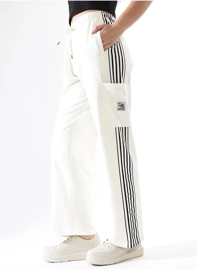 HIGH STAR Women Track Pants in Off White featuring Wide Leg fit with a solid pattern, no sleeves, regular length, secured with elasicated + drawstring closure, crafted from terry – a must-have for those who love trendy fashion.