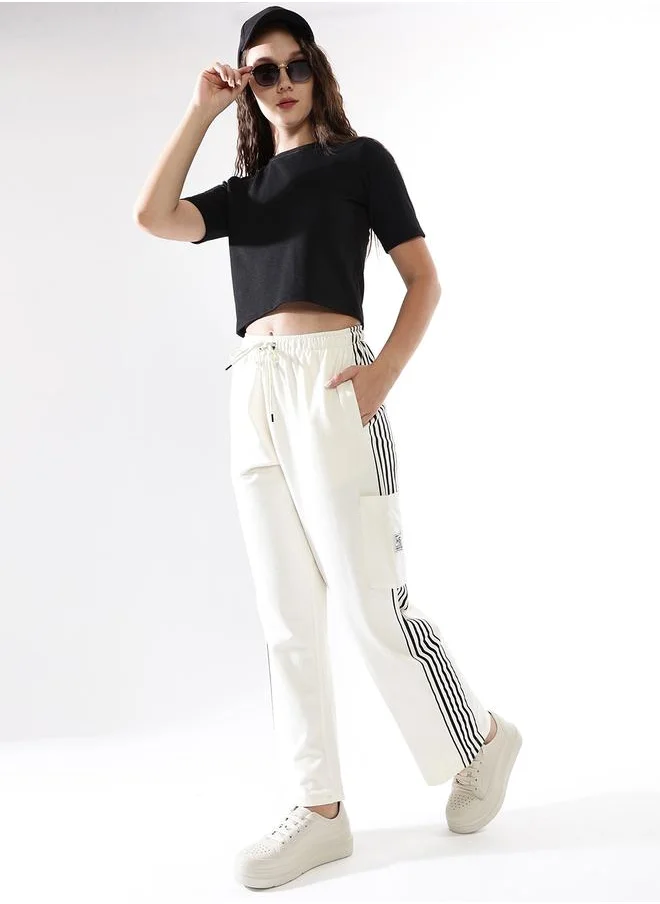 HIGH STAR Women Track Pants in Off White featuring Wide Leg fit with a solid pattern, no sleeves, regular length, secured with elasicated + drawstring closure, crafted from terry – a must-have for those who love trendy fashion.