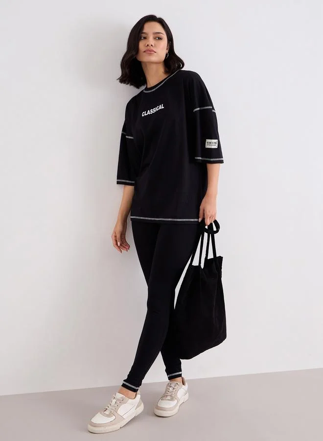 Styli Women Black Overlock Seam Oversized T-Shirt and Leggings Co-Ords