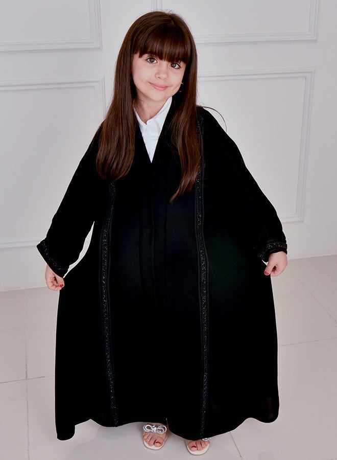 HAWRAA ABAYA Black girls’ abaya featuring long vertical embellishments, designed with a snap-button closure - Image 4