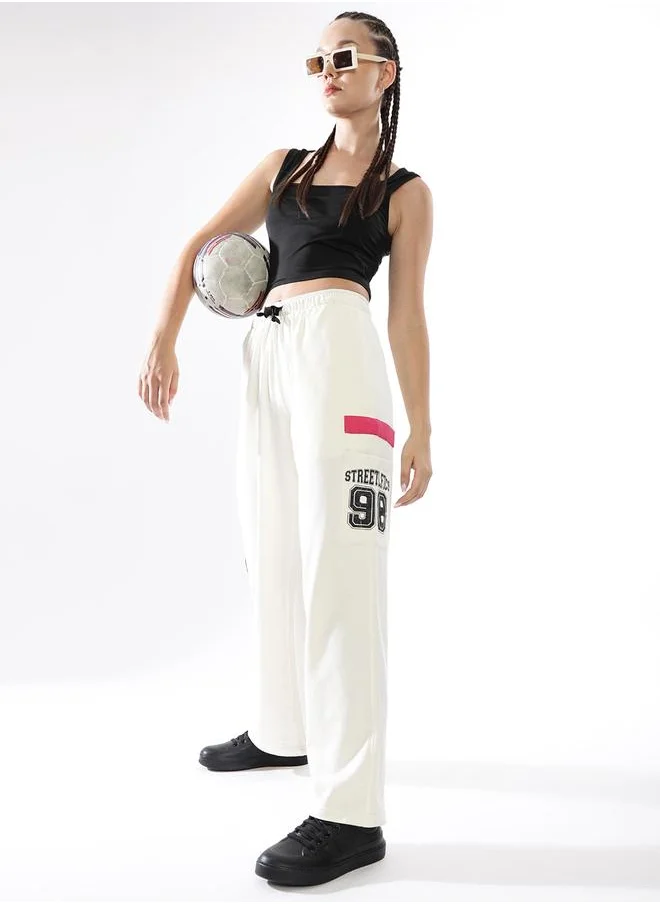 Hubberholme Women Track Pants in Off White featuring Jogger fit with a printed pattern, no sleeves, regular length, secured with elasicated + drawstring closure, crafted from terry – a trendsetting piece that blends fashion and comfort.