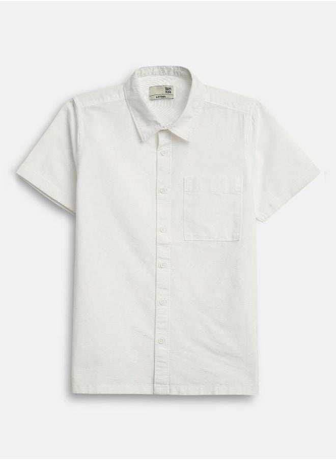 Bonkids - Boy's shirts in regular fit white colour cotton fabric embellished pattern pull over closure woven weave type round collar type round neckline half sleeve length button down upper body wear type suitable for casual occasions – where comfort meets vibrant creativity! - Image 1