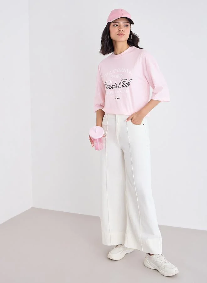 Styli Styli Women Pink Slogan Print Dropped Shoulder Oversized T-Shirt