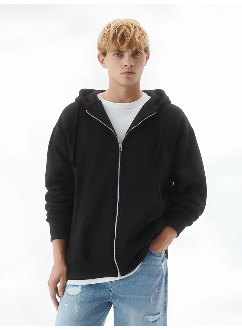 مانياك سويت شيرت رجالي أسود بقبعة وسحاب كامل وأكمام طويلة بقصة واسعة من تيري فرنسي سادة