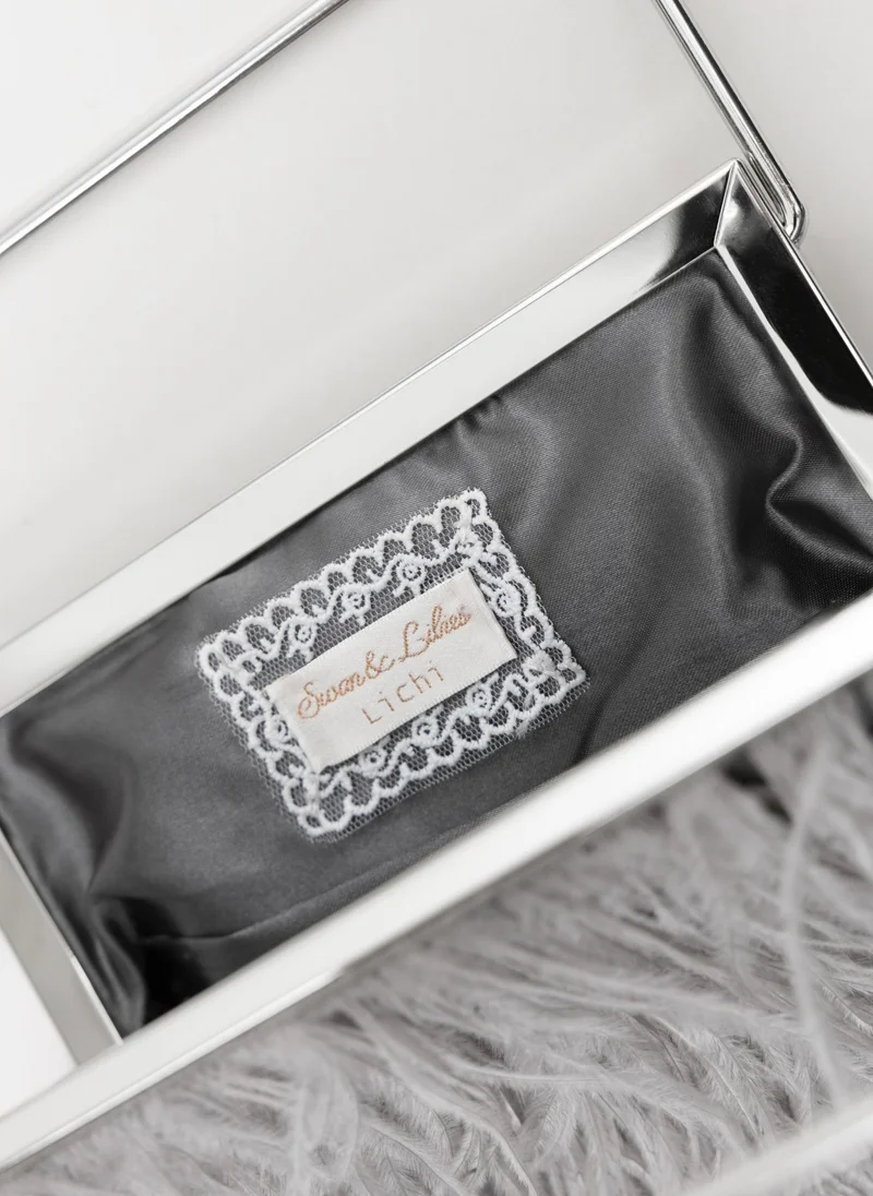 Lichi  Clutch bag with feather detailing and a metal handle for Women | Best Price UAE