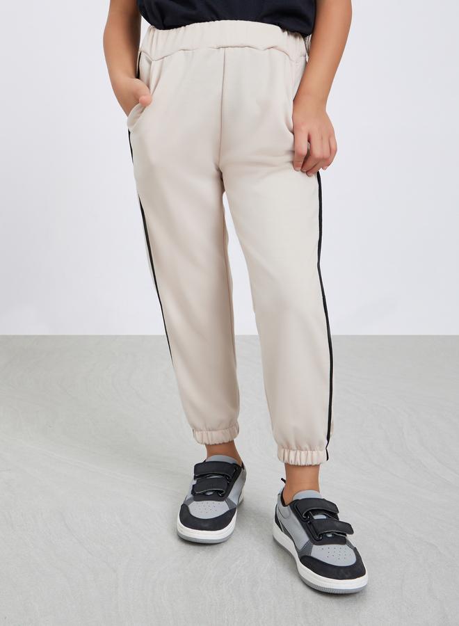 Styli Girls Beige Solid Joggers with Side Binding - Image 1