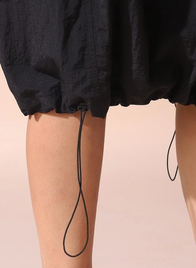 Dennis Lingo Women black regular fit solid nylon skirt with button closure- tailored to elevate your everyday.