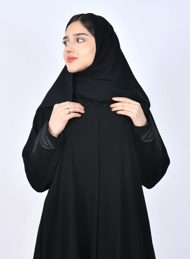 HAWRAA ABAYA Elegant black abaya with a hidden snap closure and a half-flared cut, featuring delicate sleeve embroidery for a refined touch.