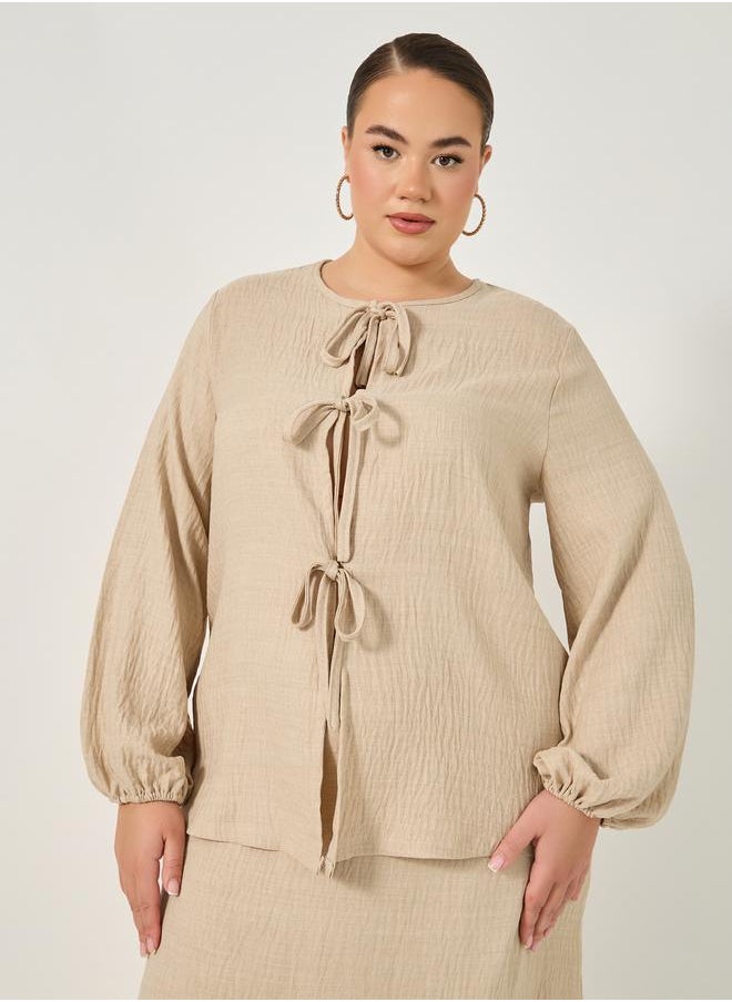 Styli Plus Size Textured Balloon Sleeve Blouse with Bow Tie-Up Detail  - Image 1