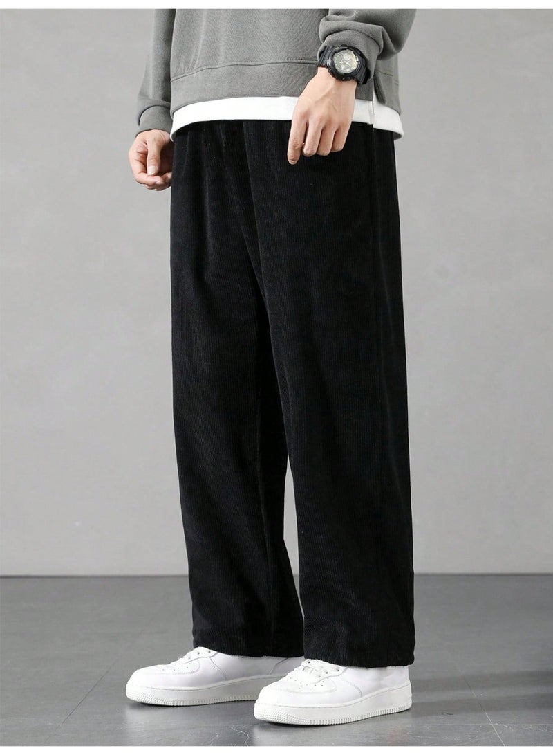 بنطلون رجالي أسود من قماش الكوردروي، واسع الساقين، بنسيج مضلع، بقصة فضفاضة، برباط، مناسب للإطلالات الكاجوال. - Image 1