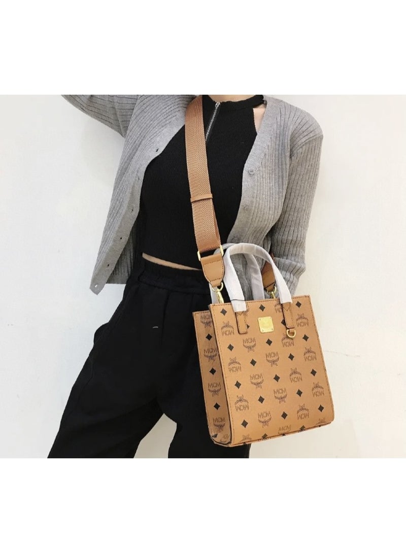 MCM Brown Monogrammed Top Handle Crossbody Bag with Adjustable Webbing Strap and Gold-tone Accents