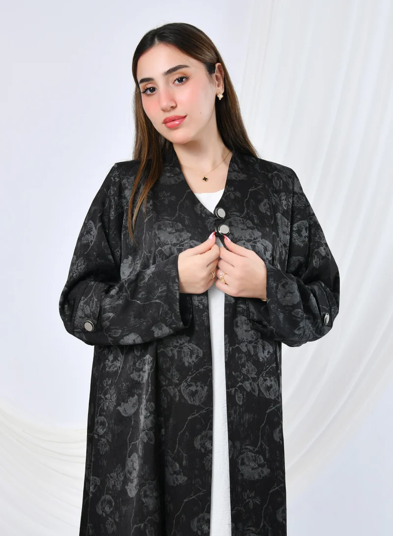 HAWRAA ABAYA Elegant silk abaya with gray floral print, buttons, and a sophisticated shiny finish.