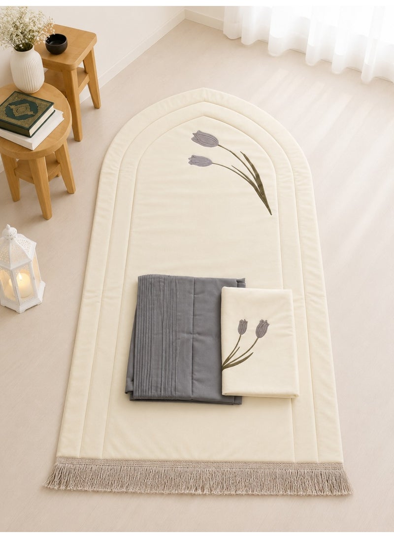 A distinctive Tulip prayer set consisting of a prayer mat with a foam lining in the shape of a mihrab, a plain prayer garment with pleats, and an attached headscarf. One large size for women.