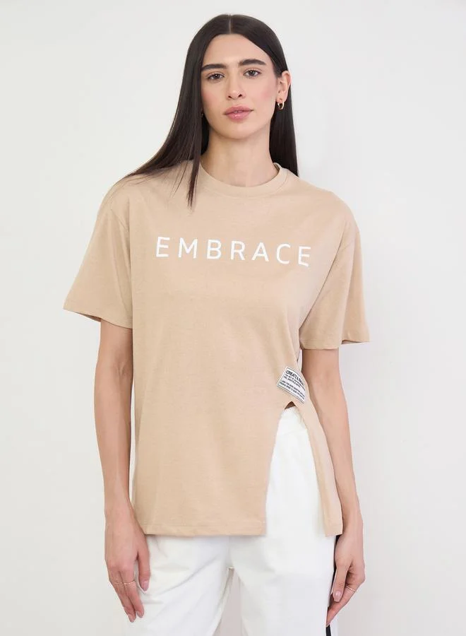 Styli Beige 100% Cotton Oversized T-Shirt with Slit and Badge Detail