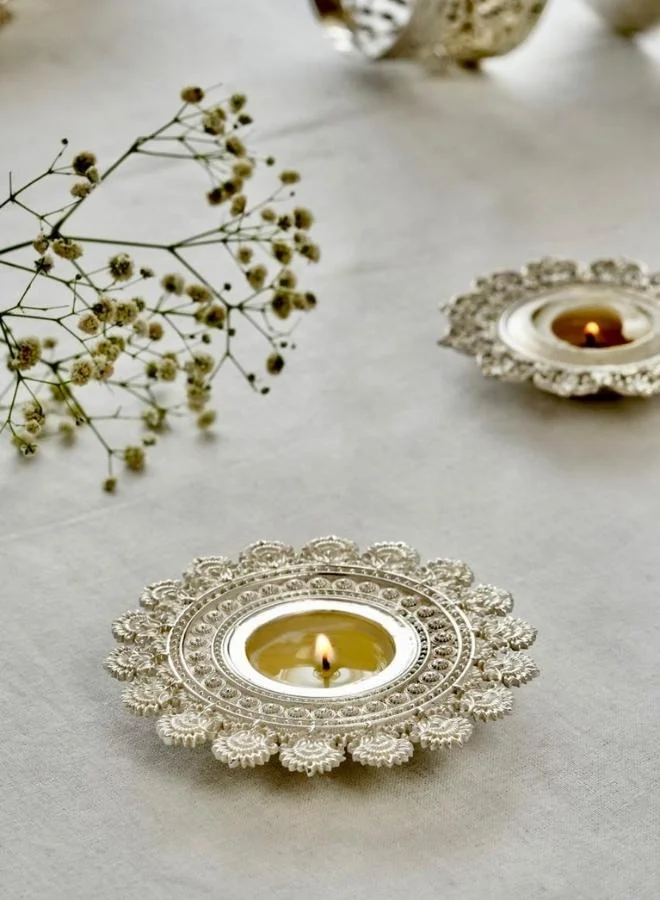 Casa Quesera Expertly handcrafted by skilled artisans, this exquisite piece features a radiant sun design symbolizing energy, warmth, and positivity. The silver-plated finish adds a touch of elegance and shine, making it a perfect accent for festive décor, spiritual settings, or everyday ambiance. Ideal for home décor or gifting, this unique tealight holder blends traditional craftsmanship with a modern aesthetic, creating a warm, inviting glow wherever it's placed.