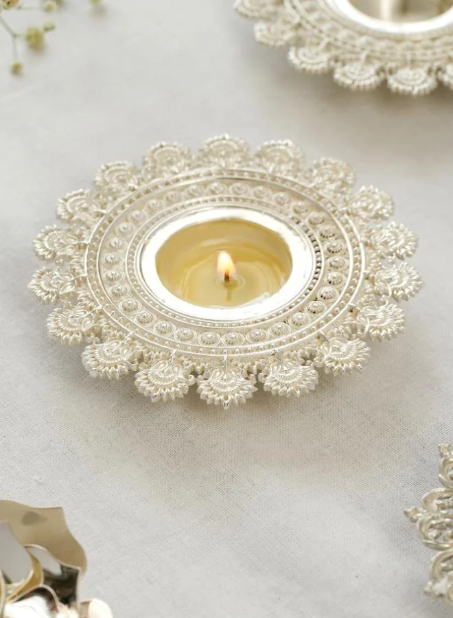 Casa Quesera Expertly handcrafted by skilled artisans, this exquisite piece features a radiant sun design symbolizing energy, warmth, and positivity. The silver-plated finish adds a touch of elegance and shine, making it a perfect accent for festive décor, spiritual settings, or everyday ambiance. Ideal for home décor or gifting, this unique tealight holder blends traditional craftsmanship with a modern aesthetic, creating a warm, inviting glow wherever it's placed.