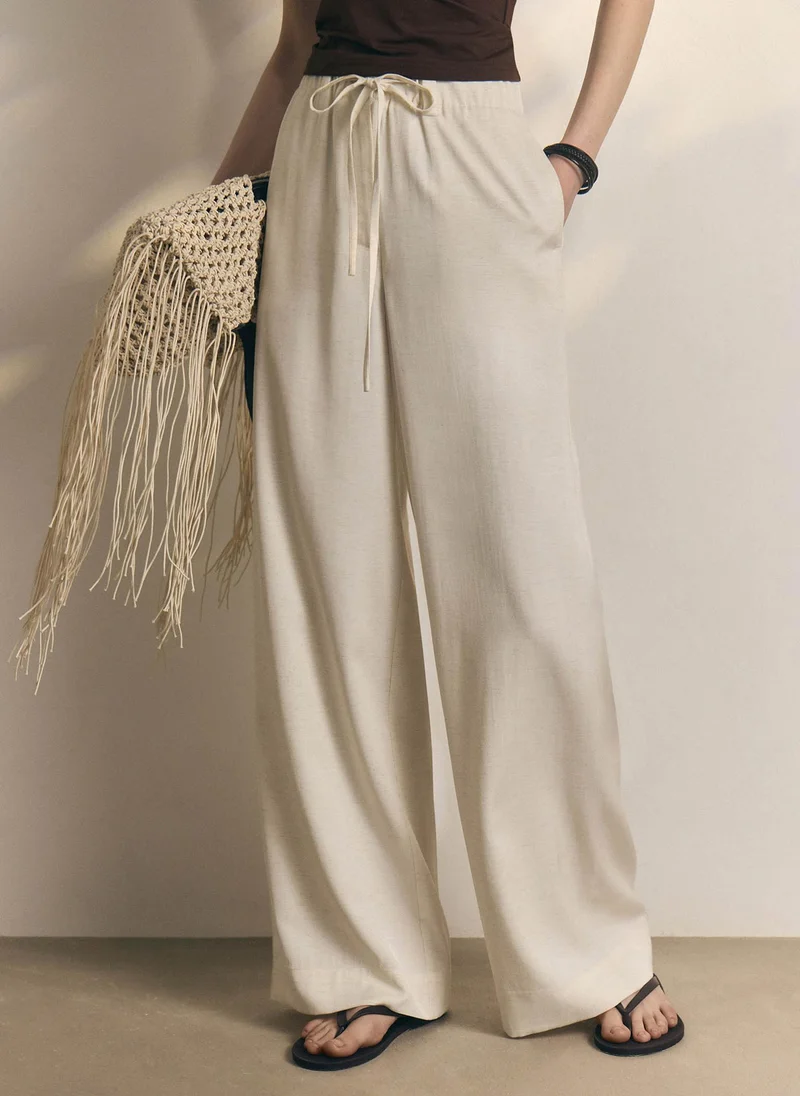 Loose-fitting viscose and linen trousers with waist ties