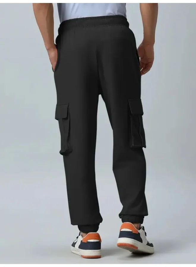 مانياك بنطلون كارغو رجالي قطن أسود سادة بجيوب جانبية بقصة واسعة
