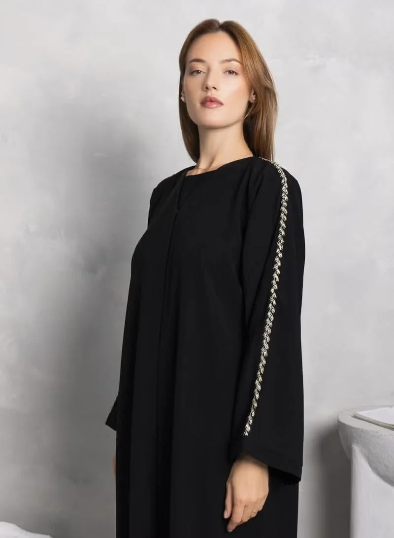 crepe abaya with beautiful thread work on sleves with tiny beads.best for work wear or evenings.