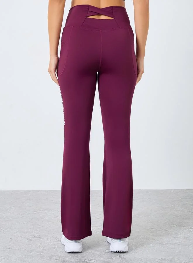 Styli Active purple Gymspire Edition - Label Broad Waist Side Pocket Flared Leggings with Text Detail for Women | Best Price UAE