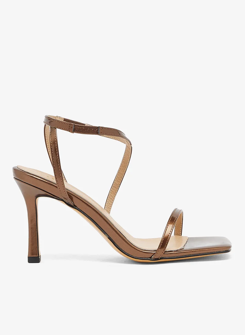 Bronze sandal with asymmetric straps and mid heel