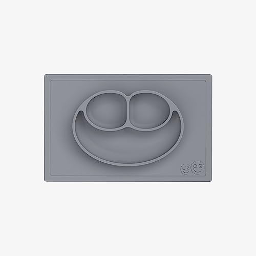 ezpz Happy Mat - 100% Food Grade Silicone Suction Plate with Built-in Placemat for Toddlers Smile Design Plates Promotes Baby Led Weaning - Divided Plate - Microwave & Oven Safe - 24months+ (Grey) - Image 1