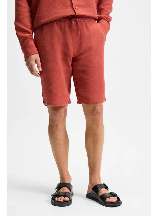 GRIMELANGE Jens Men's 100% Cotton Muslin Fabric Side‑Pocket Slim Fit Tapered Brick‑Color Shorts.