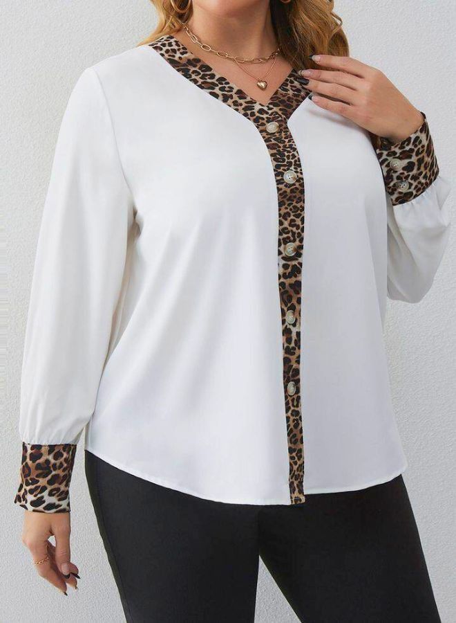A very chic women's blouse with tiger bracelets 