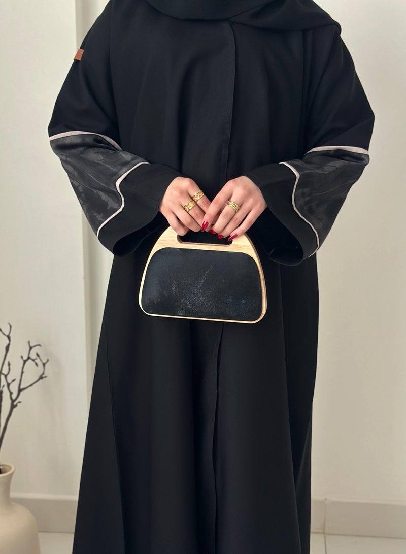 A handbag with a distinctive design with a wooden frame - Image 1