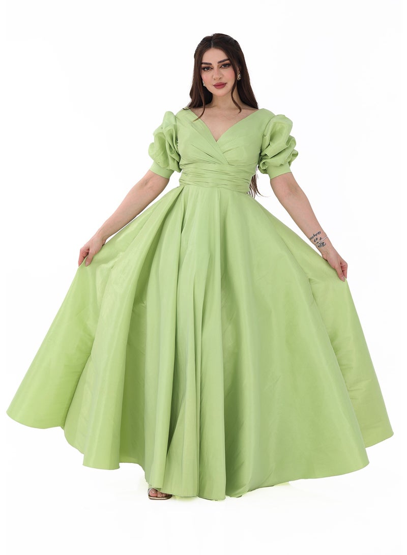 Modern Design A long green evening dress with a Roman design. This dress is designed with a bow at the top of the shoulders and elegant layers on the chest with the letter V. This dress combines an elegant design i  - Image 1