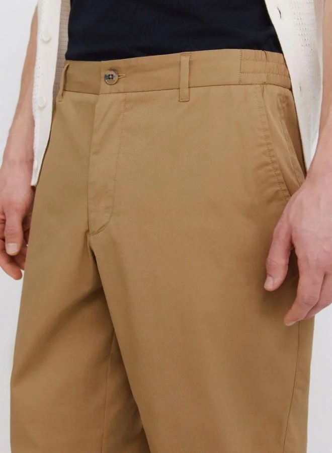 Springfield  Trousers made from a lightweight cotton and nylon blend fabric with stretch, providing comfort. They feature an elasticated waistband on both sides for enhanced comfort, and an inner drawstring for a perfect fit. Back welt pockets with button. Relax fit. for Men | Best Price UAE