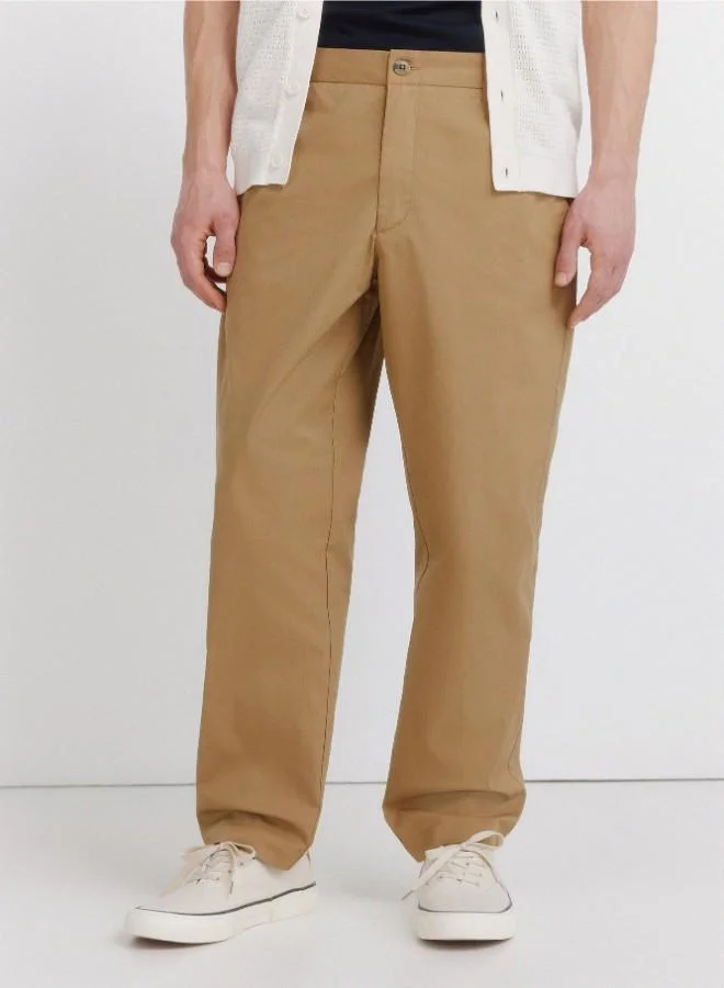Springfield  Trousers made from a lightweight cotton and nylon blend fabric with stretch, providing comfort. They feature an elasticated waistband on both sides for enhanced comfort, and an inner drawstring for a perfect fit. Back welt pockets with button. Relax fit. for Men | Best Price UAE