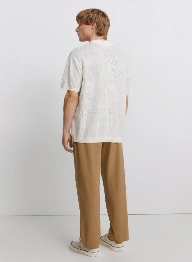 Springfield  Trousers made from a lightweight cotton and nylon blend fabric with stretch, providing comfort. They feature an elasticated waistband on both sides for enhanced comfort, and an inner drawstring for a perfect fit. Back welt pockets with button. Relax fit. for Men | Best Price UAE