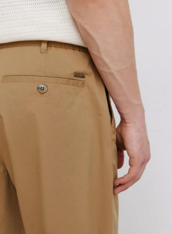 Springfield  Trousers made from a lightweight cotton and nylon blend fabric with stretch, providing comfort. They feature an elasticated waistband on both sides for enhanced comfort, and an inner drawstring for a perfect fit. Back welt pockets with button. Relax fit. for Men | Best Price UAE