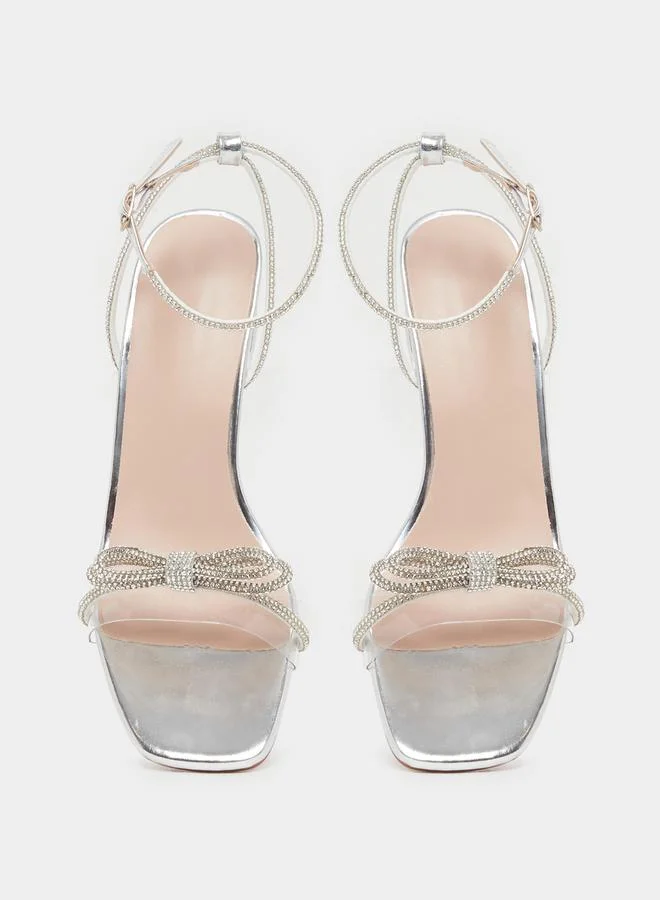 Take Two Embellished Bow Transparent Block Heel Sandals by Styli