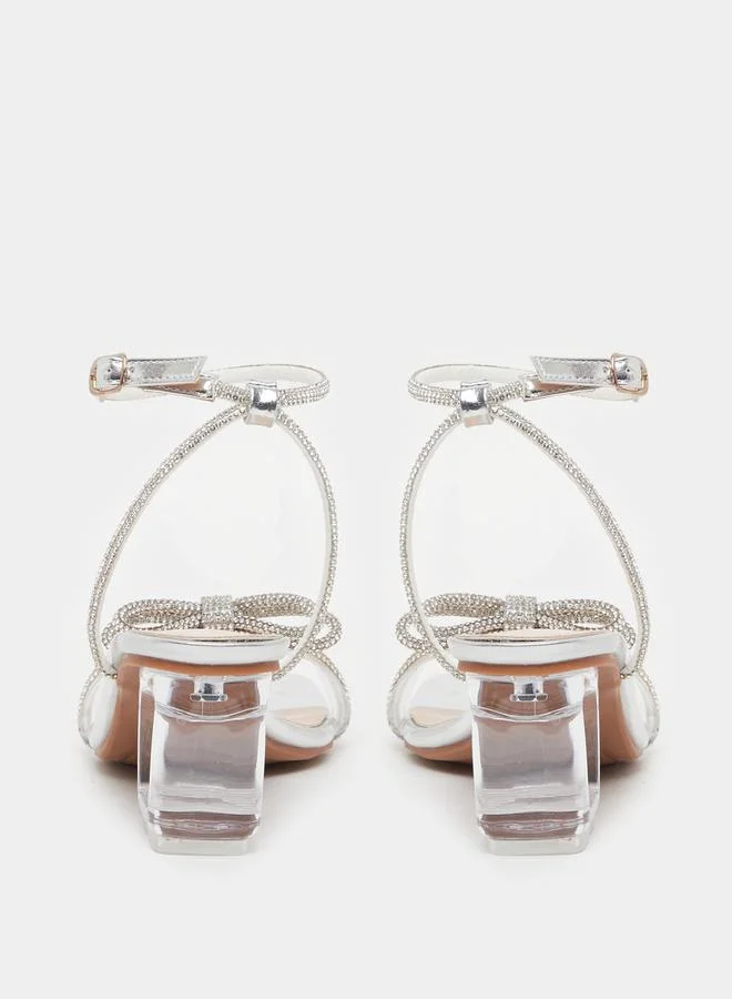 Take Two Embellished Bow Transparent Block Heel Sandals by Styli