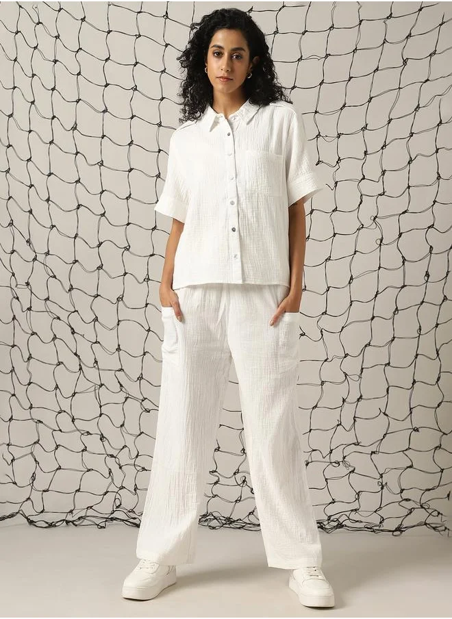 Hubberholme Women Co-ord in Off white featuring Oversized fit with a solid pattern, spread collar collar, spread collar neckline, half sleeves, regular length, secured with button closure, crafted from cotton – an essential addition to your stylish collection.