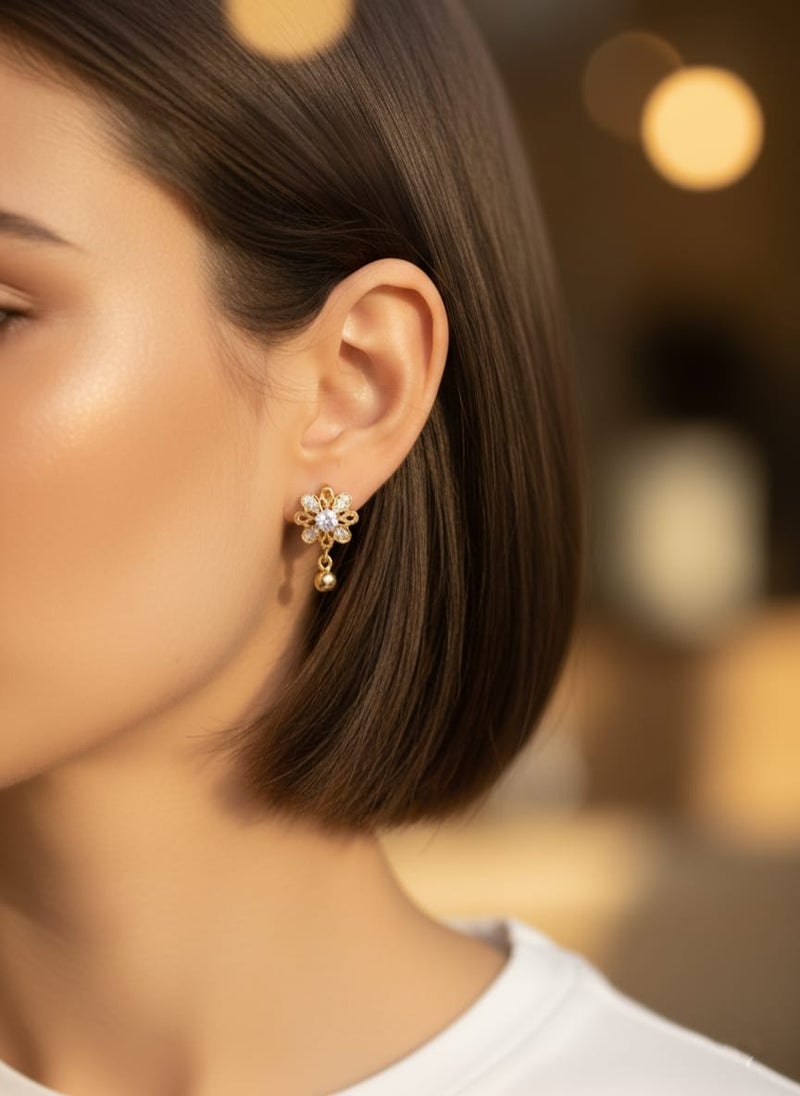 A delicate gold-plated earring featuring a sparkling flower design with dazzling stones that add elegance and radiance, completed with a small gold ball-shaped pendant. - Image 2