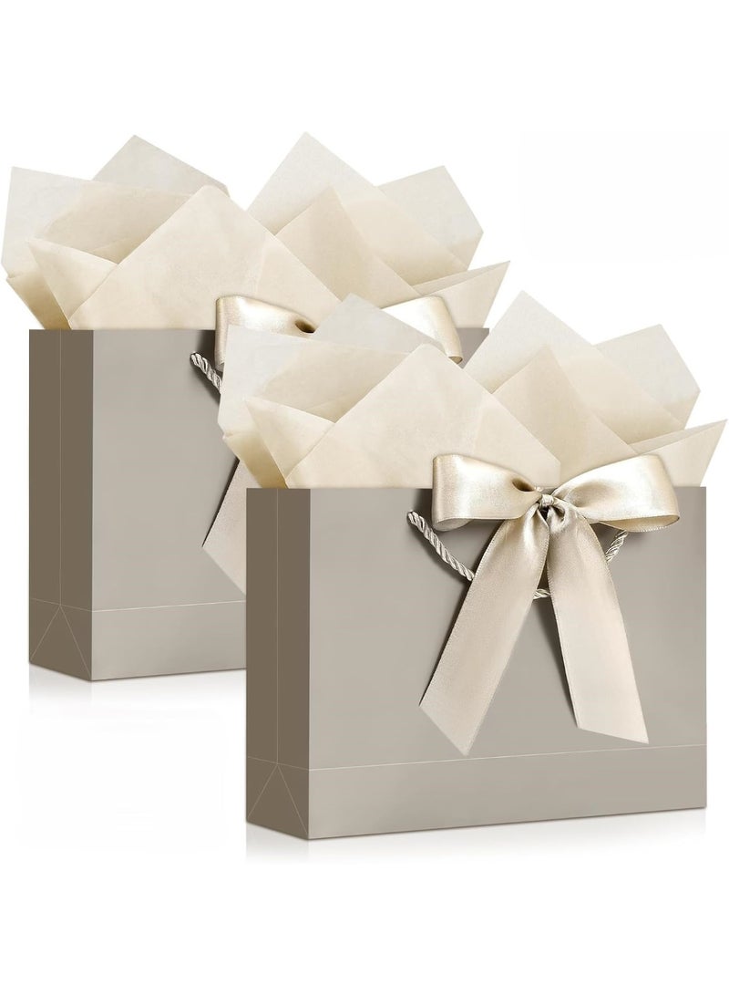 Kawkab Champagne-colored 2-piece gift bag set with handles and ribbon, includes 2 large gift bags, 4 sheets of tissue paper, and 2 greeting cards. Perfect for birthdays, weddings, holidays, parties, and special occasions. Dimensions: 32x11x25cm. - Image 1