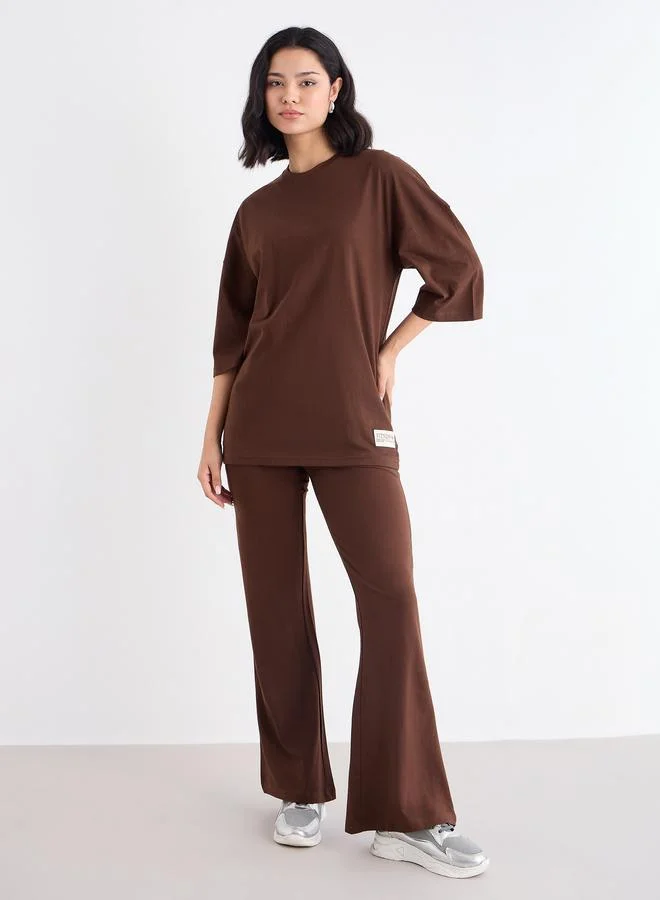 Styli Styli Patch Detail Oversized T-Shirt and Flared Leggings Co-Ords