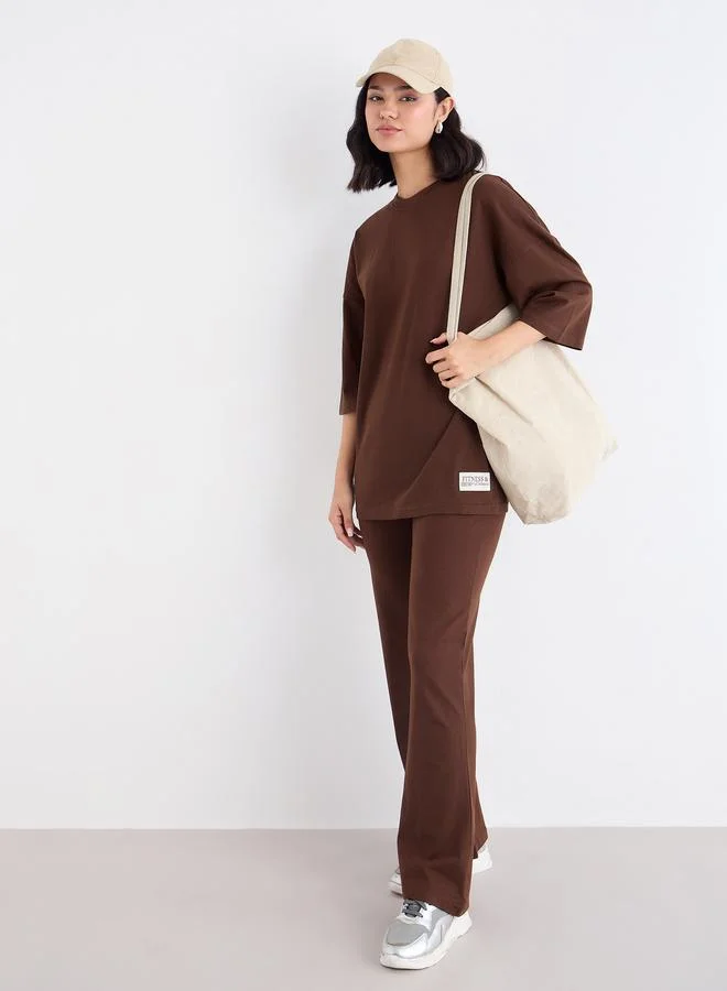 Styli Styli Patch Detail Oversized T-Shirt and Flared Leggings Co-Ords
