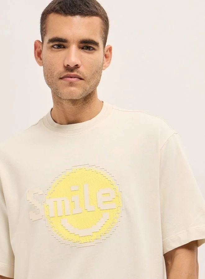 THE BEAR HOUSE  Men's Cream Pixelated Smiley Face Oversize Crew Neck T-shirt Perfect For Casual Wear, Gym, Travel, Or Layering Stylish And Versatile Essential For Every Wardrobe for Men | Best Price UAE