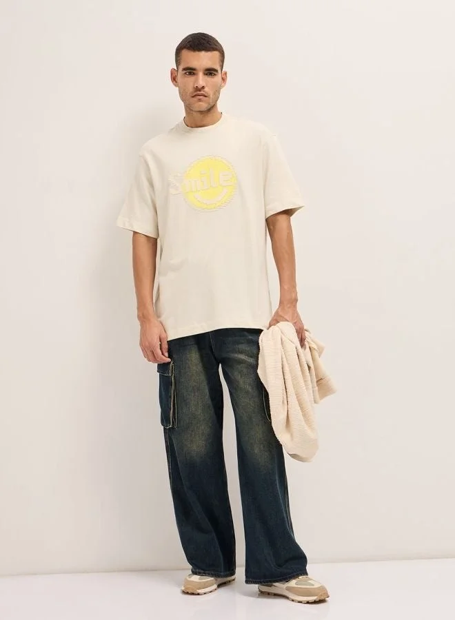 THE BEAR HOUSE  Men's Cream Pixelated Smiley Face Oversize Crew Neck T-shirt Perfect For Casual Wear, Gym, Travel, Or Layering Stylish And Versatile Essential For Every Wardrobe for Men | Best Price UAE