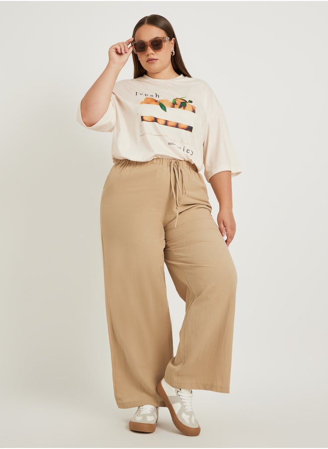 Styli Plus Size Solid Wide Leg Pants with Drawstring Waist  - Image 1