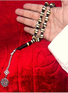 Luxurious rosary made of natural cocoa wood It contains a metal Trabzon tassel, characterized by its beautiful details as it contains a mixture of shells and wonderful mirrors and a soft cylindrical shape, designed to show the elegance of its owner and the strength of his presence, elegance and high taste, the thread is characterized by overlapping colors and is durable and cohesive, contains 33 beads 8 mm, its weight is suitable and suits all tastes and ages. We offer it in a box to make it easy to gift to family, loved ones and friends Suitable for all seasons Hajj, Umrah, Ramadan and holiday decorations
